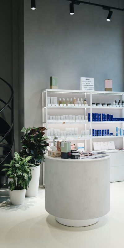 Contemporary beauty store interior showcasing various cosmetics on elegant shelves.